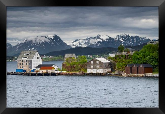 Wooden Buildings and Mountains in Alesund Norway Framed Print by Martyn Arnold