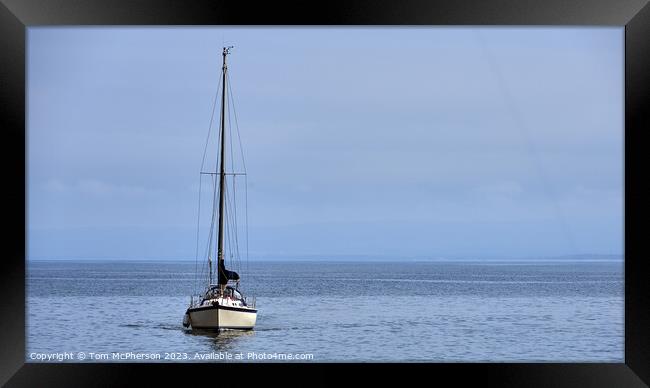 "Solitude: A Lone Yacht Sailing on the Serene Mora Framed Print by Tom McPherson