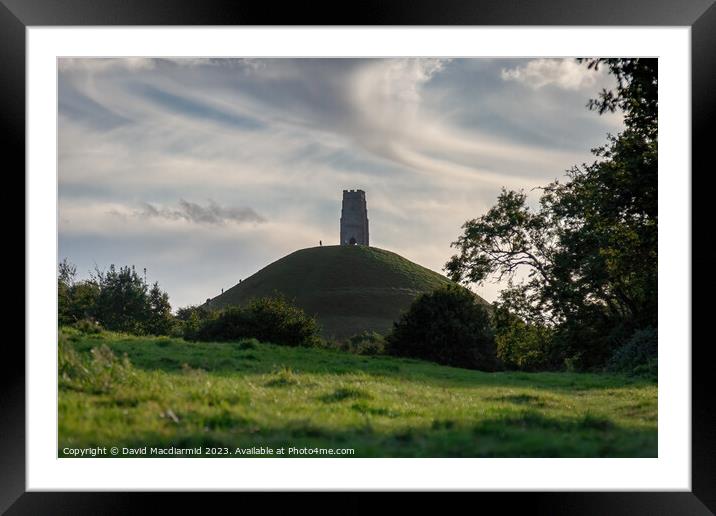 A large green field with trees in the background with Glastonbury Tor in the background Framed Mounted Print by David Macdiarmid