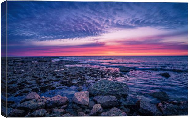 Tranquil Sunset Reflection on Rocky Shore Canvas Print by Jonny Gios