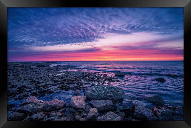 Tranquil Sunset Reflection on Rocky Shore Framed Print by Jonny Gios