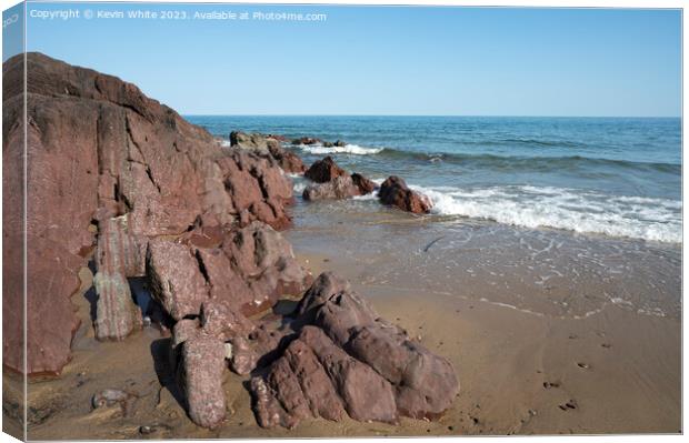 Millions of years old rocks at end of Freshwater East beach Canvas Print by Kevin White