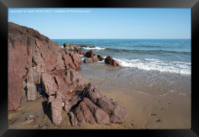 Millions of years old rocks at end of Freshwater East beach Framed Print by Kevin White