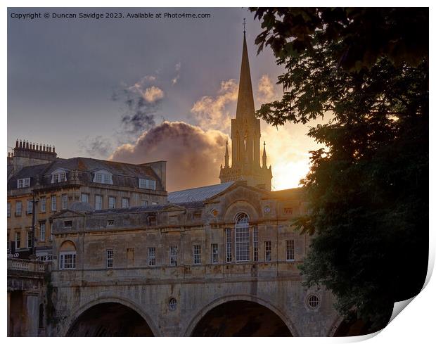 Setting sun behind Pulteney Bridge Bath Print by Duncan Savidge