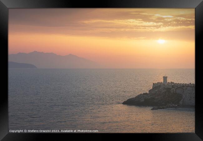 Lighthouse of Piombino at sunset and Elba island. Framed Print by Stefano Orazzini