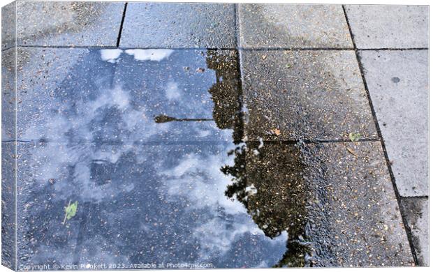 Sidewalk reflections from a rain  puddle Canvas Print by Kevin Plunkett