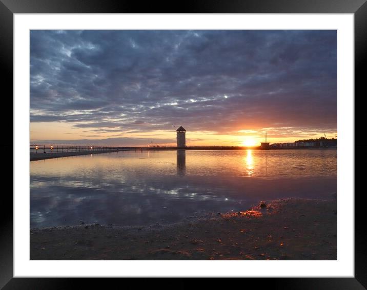 Sun setting over Batemans Tower in Brightlingsea in full reflections  Framed Mounted Print by Tony lopez
