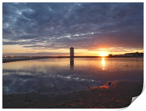 Sun setting over Batemans Tower in Brightlingsea in full reflections  Print by Tony lopez
