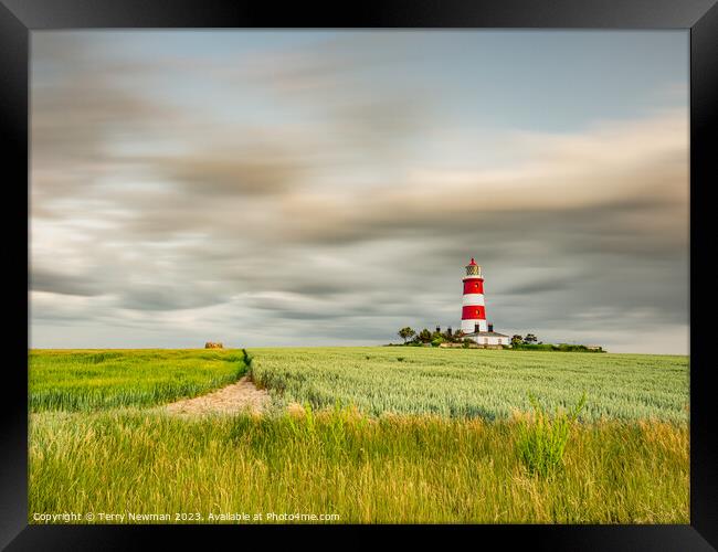 Happisburgh Lighthouse with a dramatic sky Framed Print by Terry Newman