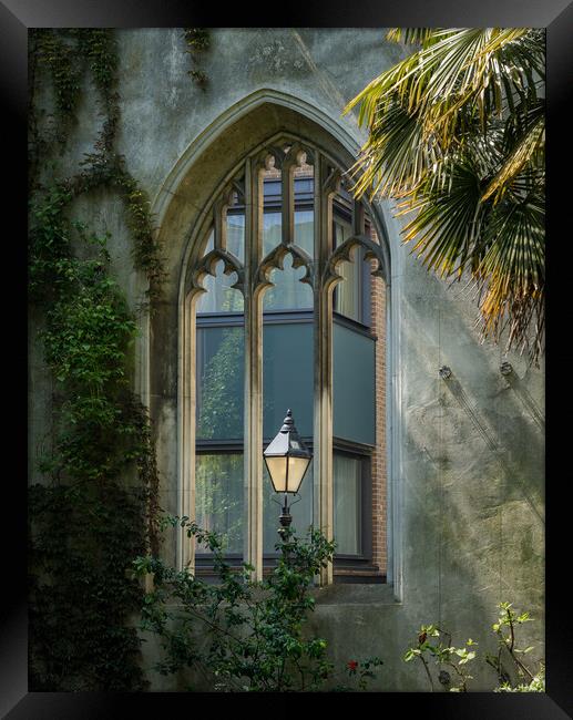 London street light seen through old windows of St Dunstan Framed Print by Steve Heap