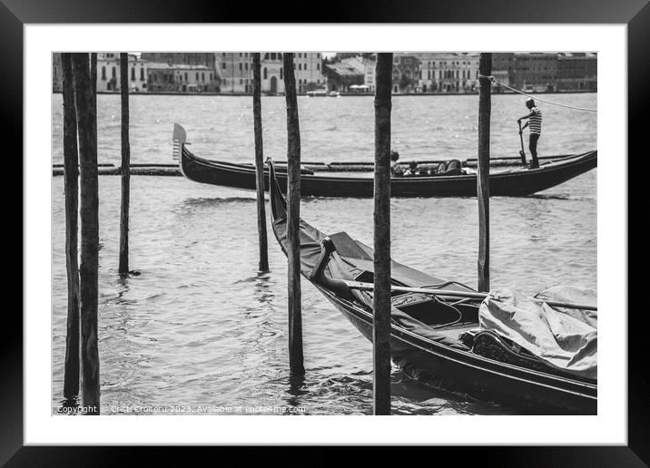 A gondolier or venetian boatman propelling a gondola on Grand Canal in Venice. Black and white photography. Framed Mounted Print by Cristi Croitoru