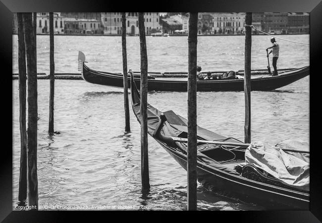 A gondolier or venetian boatman propelling a gondola on Grand Canal in Venice. Black and white photography. Framed Print by Cristi Croitoru