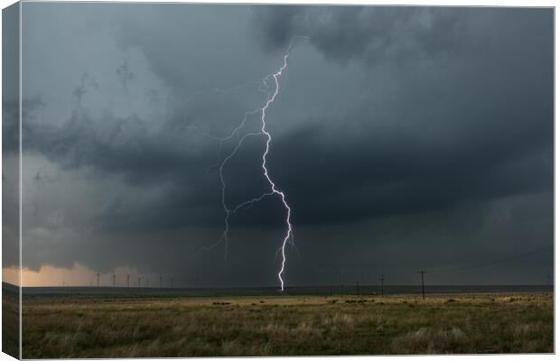 Lightning over a wind-farm in New Mexico. Canvas Print by John Finney