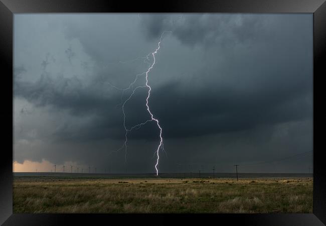 Lightning over a wind-farm in New Mexico. Framed Print by John Finney