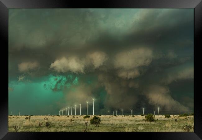Spectacular Supercell over a windfarm. New Mexico. Framed Print by John Finney