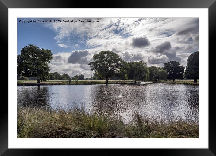 Dramatic rain clouds forming over Bushy Park ponds Framed Mounted Print by Kevin White