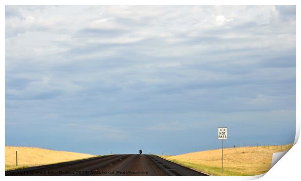 Lone biker on an empty rural road with 'Do Not Pass' sign in the foreground Print by Madeleine Deaton
