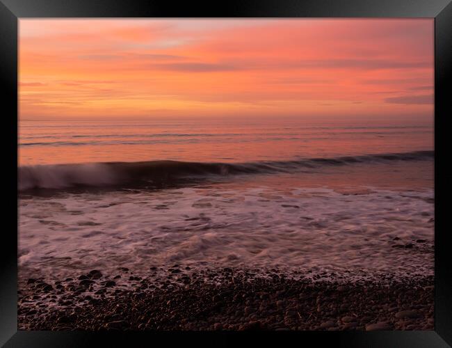 Sunset wave lapping the shoreline Framed Print by Tony Twyman