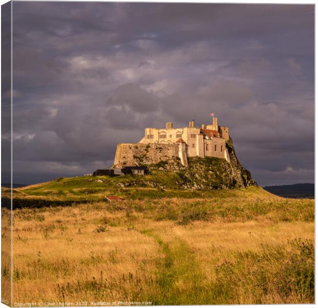 Storm clouds over Lindisfarne Castle Canvas Print by Clive Ingram
