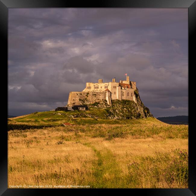 Storm clouds over Lindisfarne Castle Framed Print by Clive Ingram