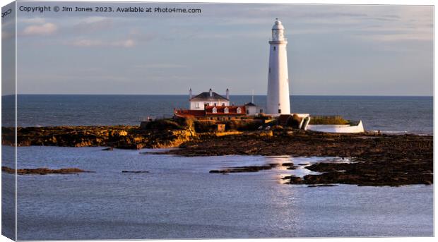 St Mary's Island and Lighthouse caught in a shaft of sunlight. Canvas Print by Jim Jones