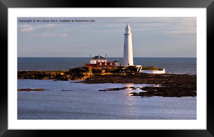 St Mary's Island and Lighthouse caught in a shaft of sunlight. Framed Mounted Print by Jim Jones
