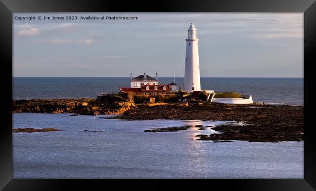 St Mary's Island and Lighthouse caught in a shaft of sunlight. Framed Print by Jim Jones