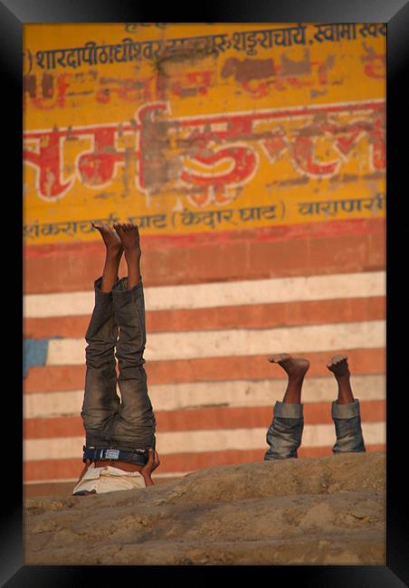 Doing Yoga on the Ghats at Varanasi Framed Print by Serena Bowles