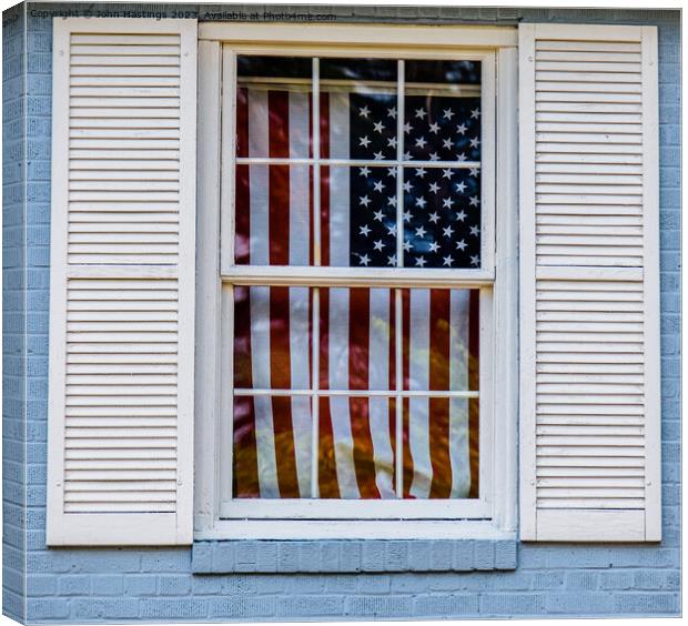 Old Glory through an old window Canvas Print by John Hastings