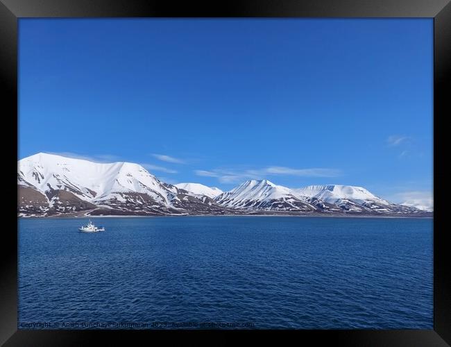 Serene Winter Landscape: Majestic Mountains, Pristine Snow, and Tranquil Sea a view from svalbard and jan mayen norway Framed Print by Anish Punchayil Sukumaran