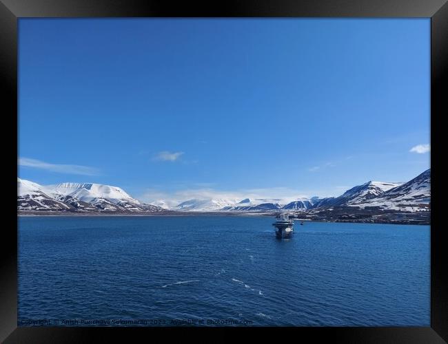 Serene Winter Landscape: Majestic Mountains, Pristine Snow, and Tranquil Sea a view from svalbard and jan mayen norway Framed Print by Anish Punchayil Sukumaran