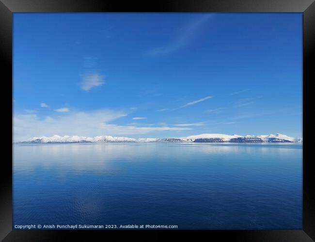 Architectural beauty against mountainous coastline with nautical vessel sailing on calm waters. a view from salbard longyearbyen norway Framed Print by Anish Punchayil Sukumaran