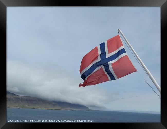 Norwegian Flag Fluttering Proudly Against Clear Blue Sky Framed Print by Anish Punchayil Sukumaran