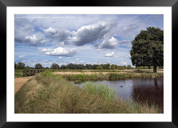 Bushy Park boat pond with pedestrian bridge across stream Framed Mounted Print by Kevin White