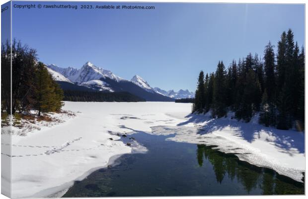 Snowy Maligne Lake Amidst White Peaks Canvas Print by rawshutterbug 