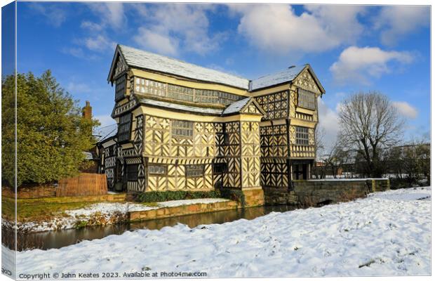 Little Moreton Hall, Cheshire in the winter snow.  Canvas Print by John Keates