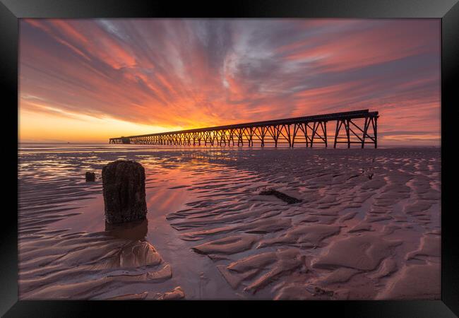 Sunrise over the pier Framed Print by Kevin Winter