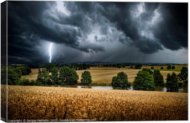 Lightning strike through the storm clouds over rural countryside. Canvas Print by Sergey Fedoskin