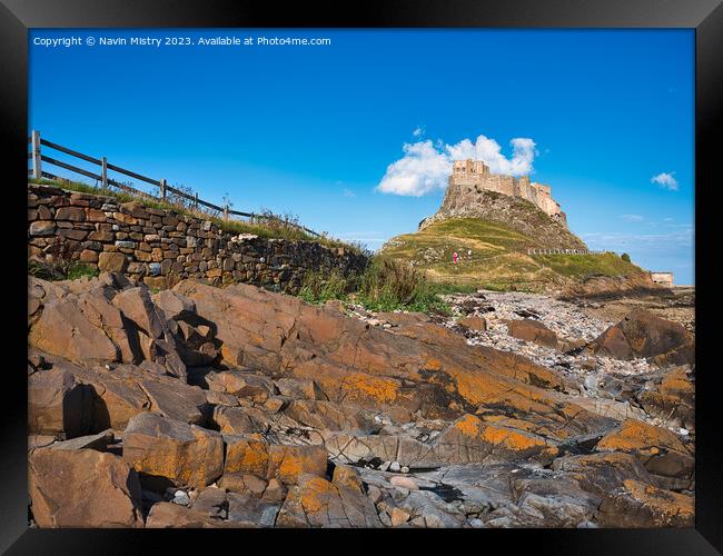 Lindisfarne Castle seen from the shore line Framed Print by Navin Mistry