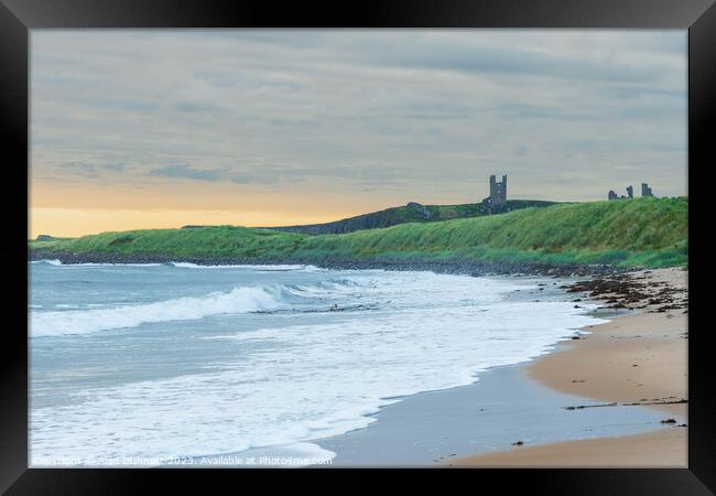 Coastal Serenity Unveiled at Dunstanburgh Framed Print by Alan Dunnett