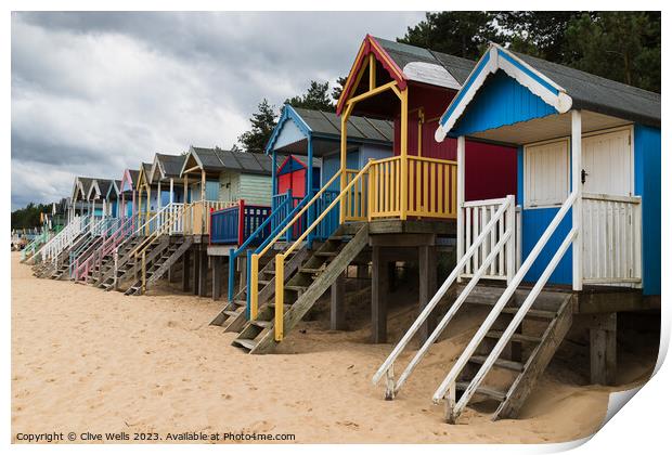 Colourful beach huts Print by Clive Wells