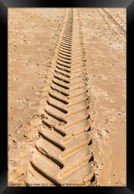Tracks in the sand Framed Print by Clive Wells