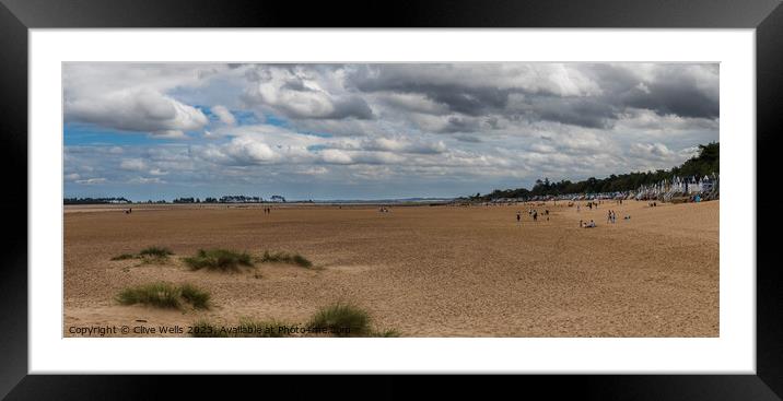 Beach in front of beach huts Framed Mounted Print by Clive Wells