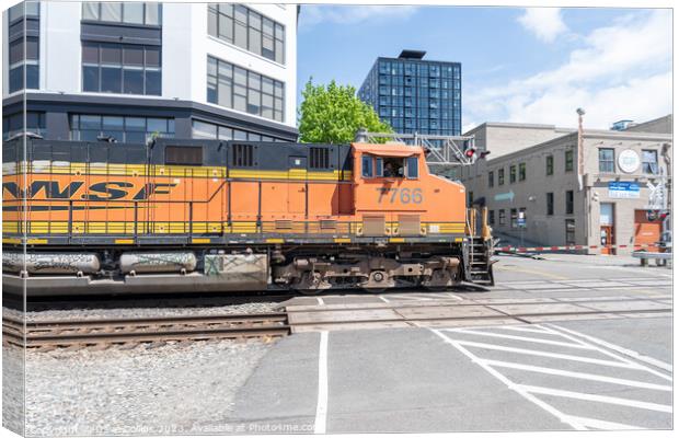 BNSF freight train on a level crossing from Alaskan Way, Seattle, USA Canvas Print by Dave Collins