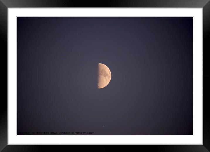 Half moon with an aeroplane directly underneath Framed Mounted Print by Helen Reid