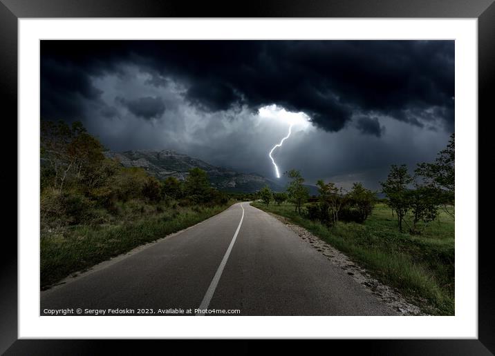 Lightning over mountains road Framed Mounted Print by Sergey Fedoskin