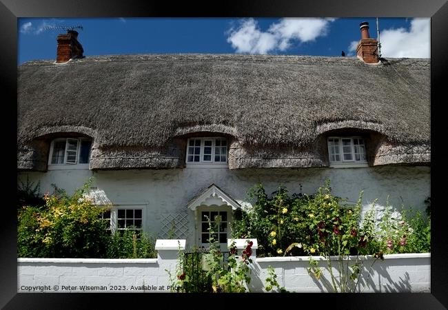  A thatched cottage  in Avebury Framed Print by Peter Wiseman