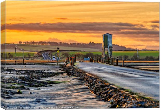 The Lindisfarne Causeway at dusk Canvas Print by Robert Mowat