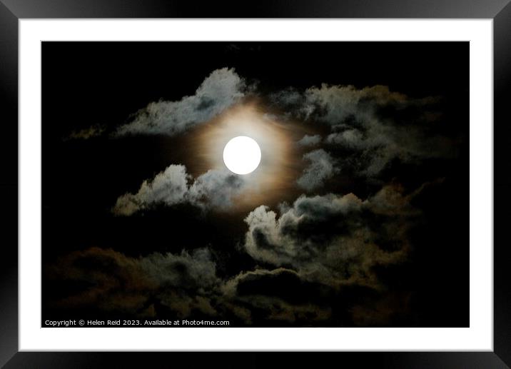 Dark super moon surrounded by clouds Framed Mounted Print by Helen Reid