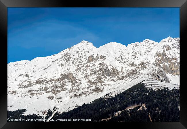 Landscape of snow capped mountains and ski resort  Framed Print by Ambrosini V